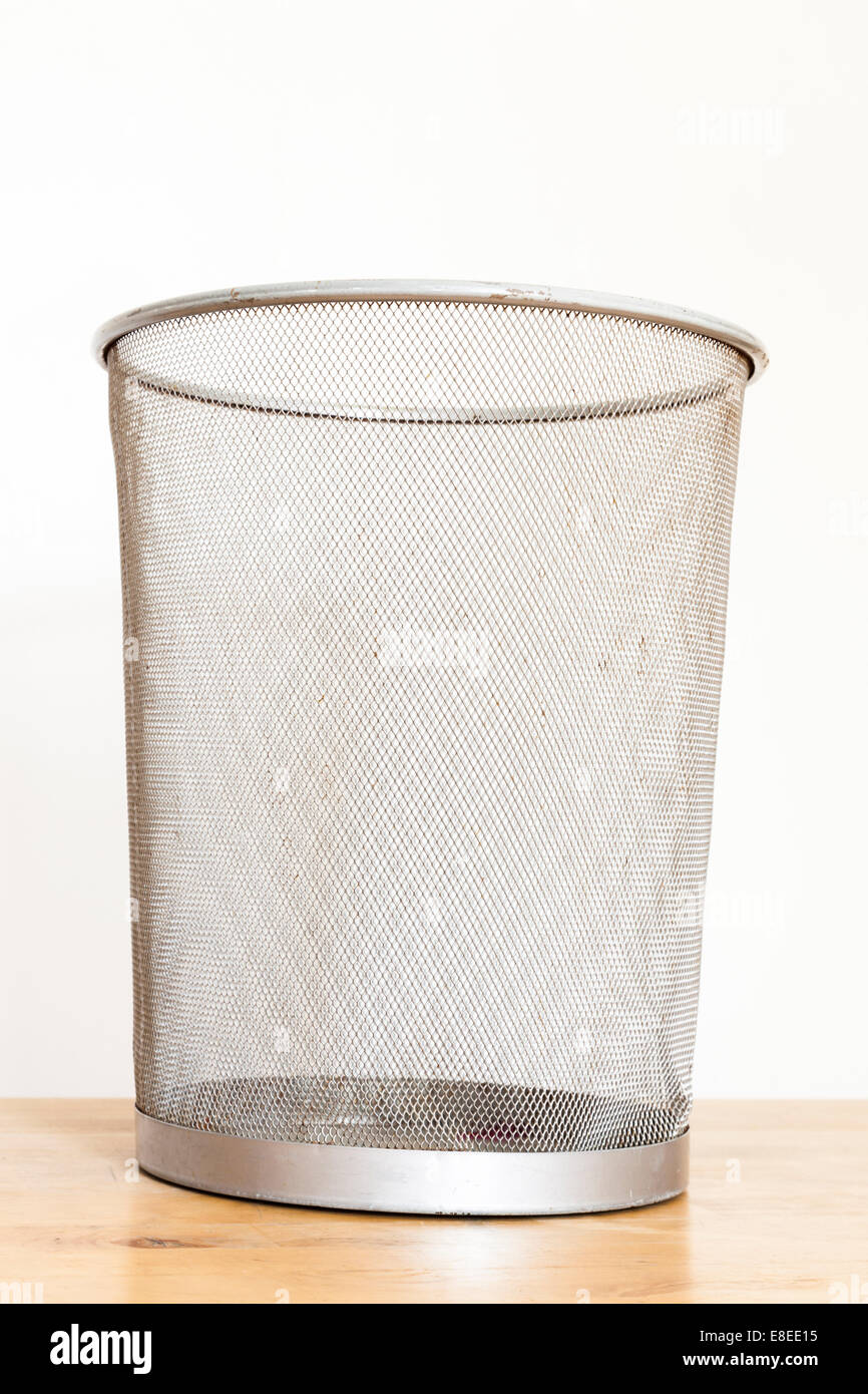Empty and slightly battered old metal waste paper basket Stock Photo