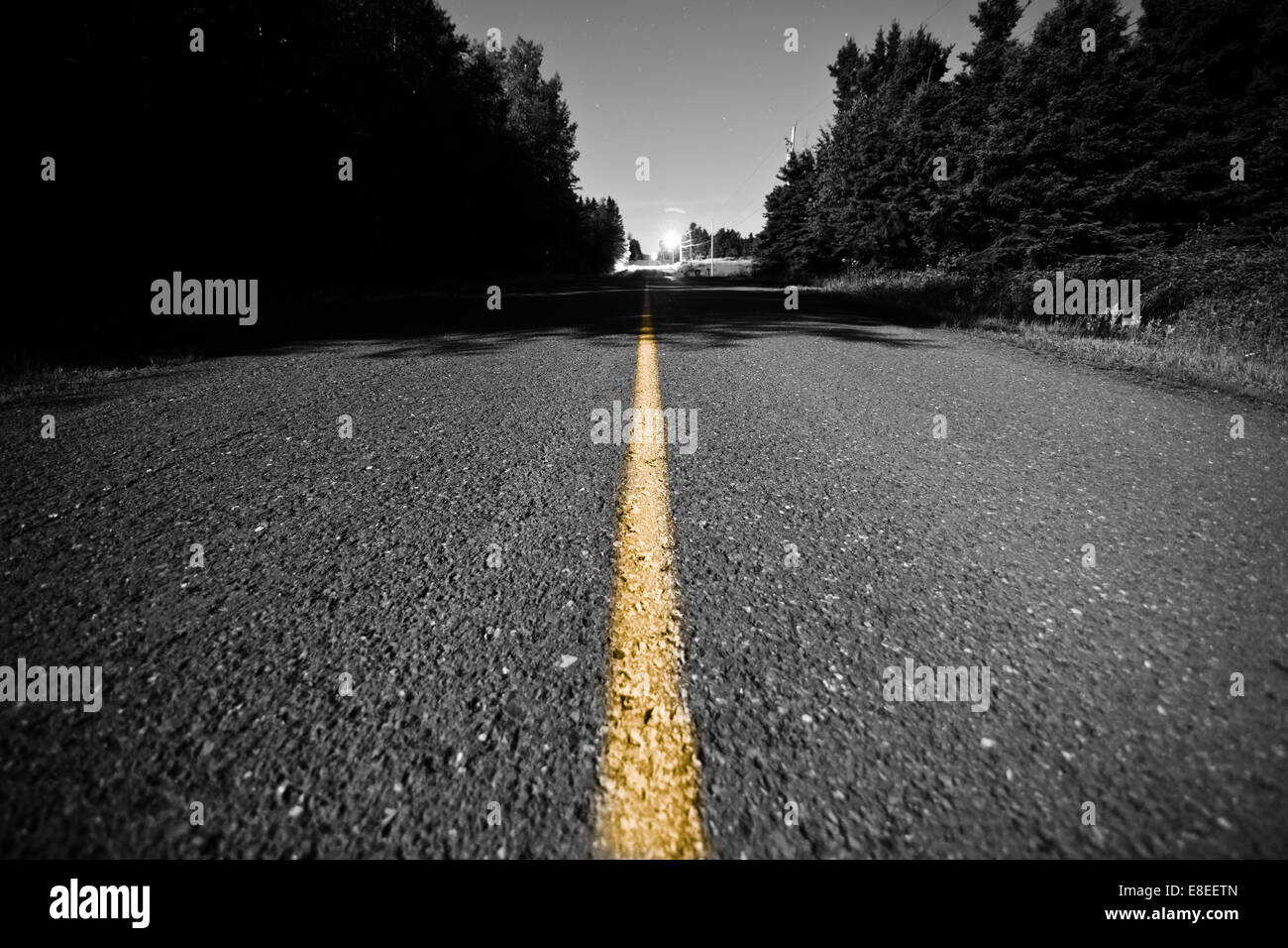Empty Country road with Yellow Dividing line at Night Stock Photo