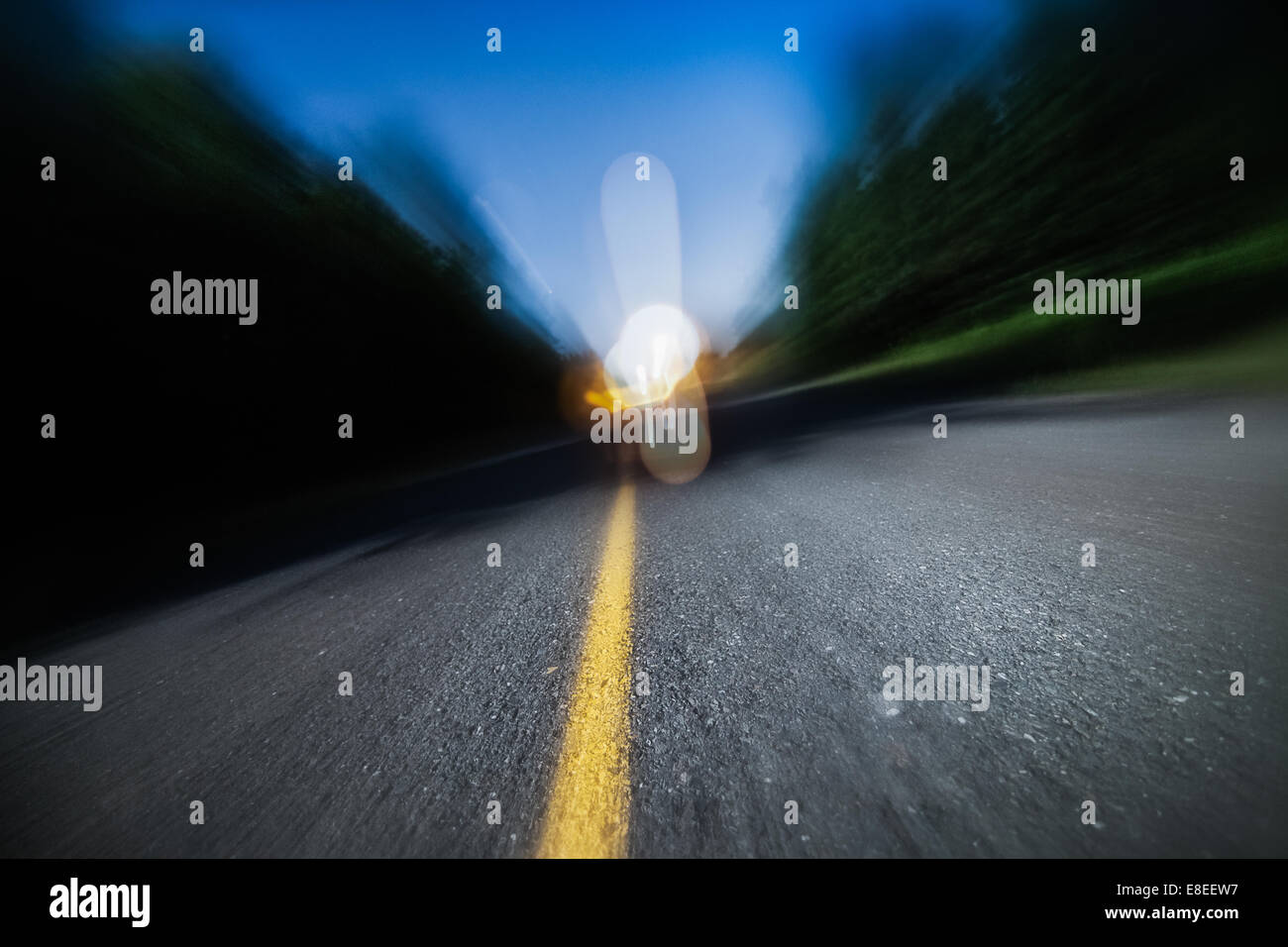 Drunk Driving, Speeding, Being too Tired to Drive are Potential Concepts for This Image of Blurry Road at Night Stock Photo