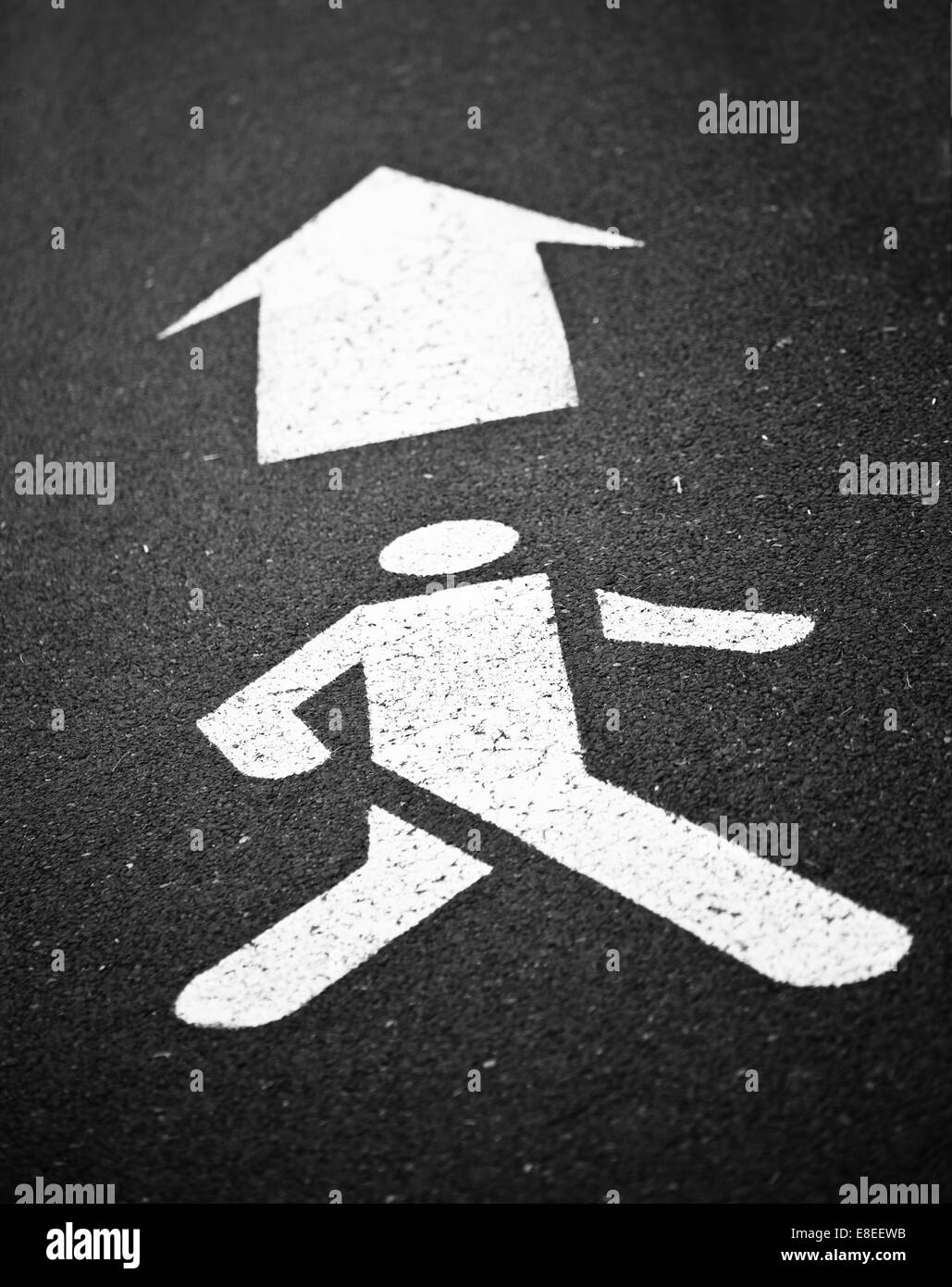 White Pedestrian Symbole Painted with Arrow Sign Stock Photo