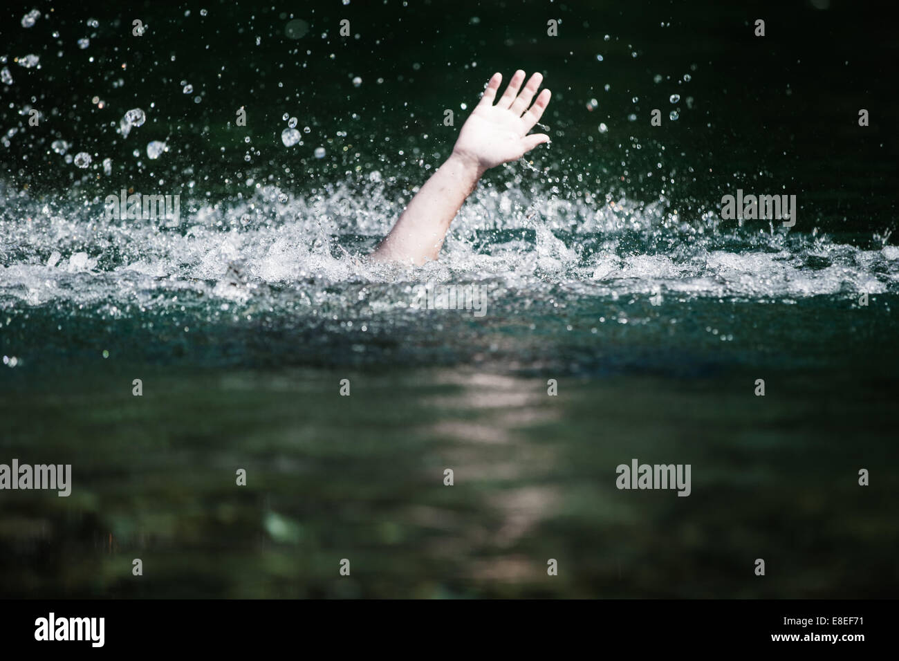 Moving Hand of Someone Drowning and in Need of Help Stock Photo