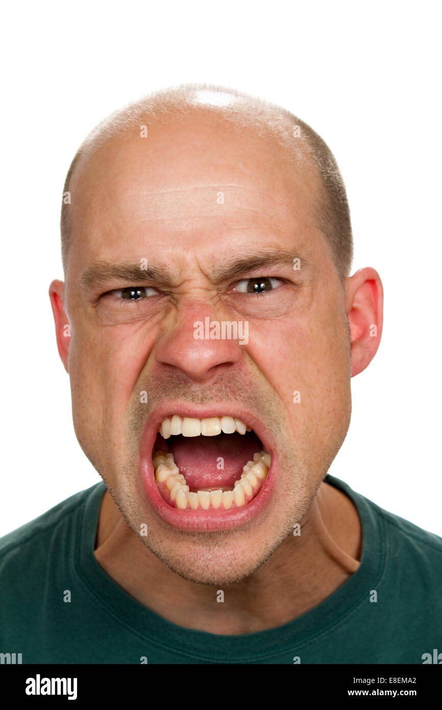 Angry and mad man screams with his mouth wide open showing his rage. Stock Photo