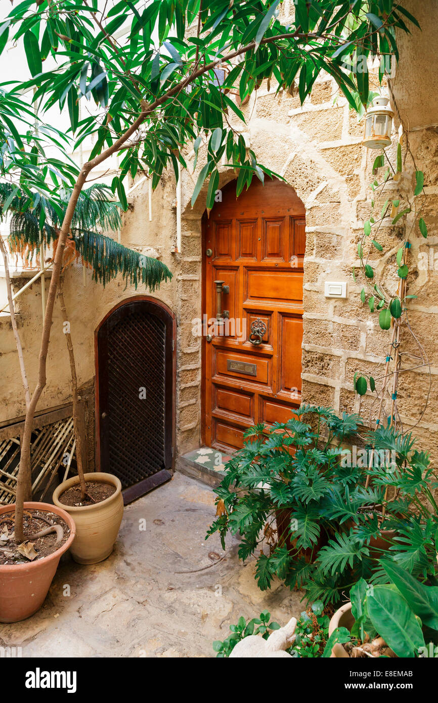 beautiful wooden door in a cozy courtyard Stock Photo