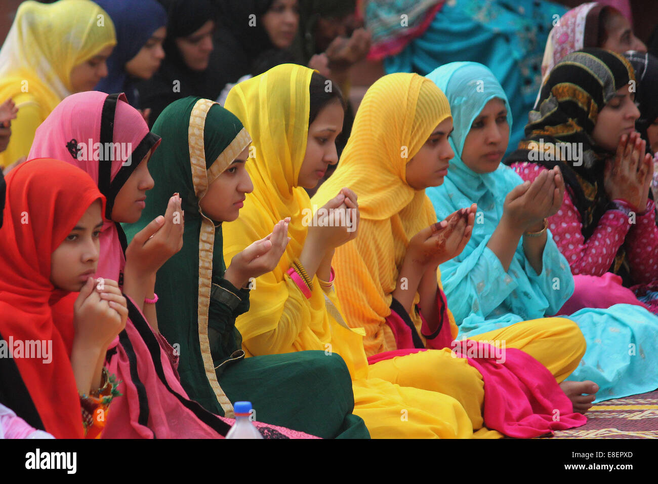 Lahore, Pakistan. 6th October, 2014. Pakistani Muslim women devotees take part in the Congregational prayers of Eid al-Adha in Lahore. Muslims around the world celebrate the Eid al-Adha feast by slaughtering cattle, goats and sheep in commemoration of the Prophet Abraham's readiness to sacrifice his son to show obedience to God. Credit:  Rana Sajid Hussain/Pacific Press/Alamy Live News Stock Photo