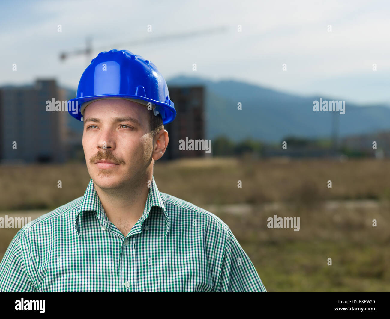 portrait of handsome caucasian engineer on construction site outdoors Stock Photo