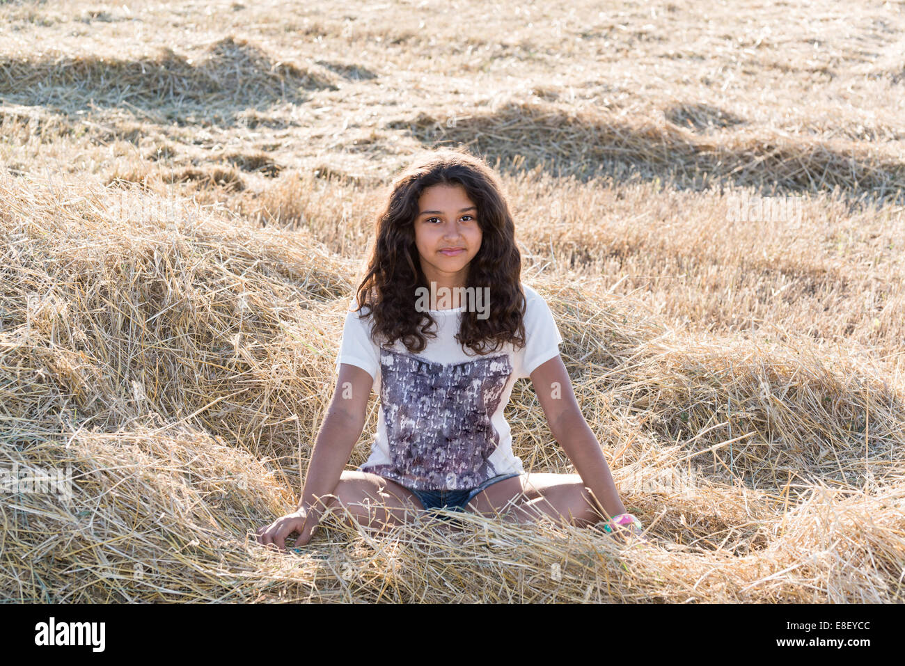 Teen girl with curly dark hair on nature Stock Photo - Alamy