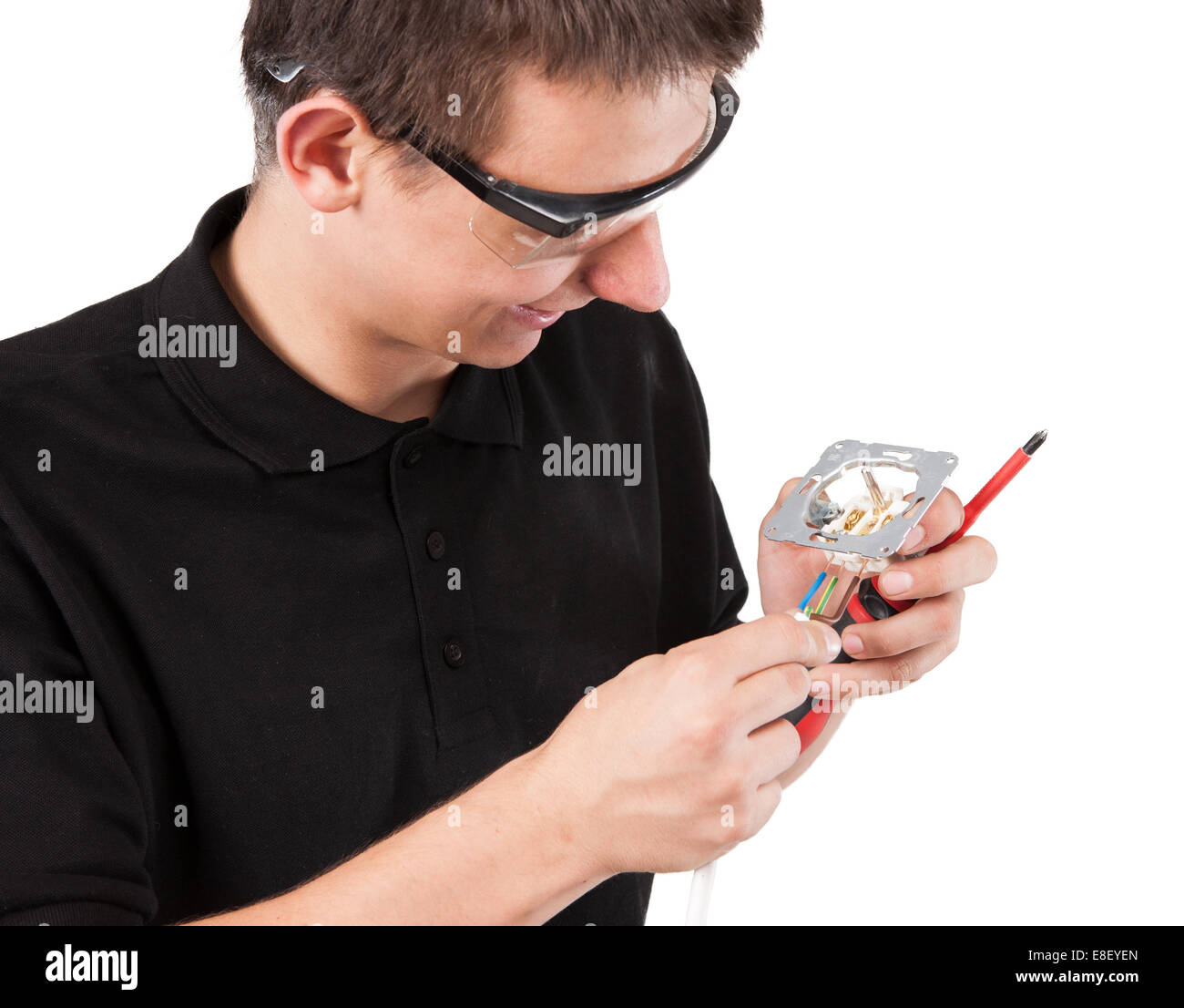 Male serviceman working with cables and electrical outlet Stock Photo ...