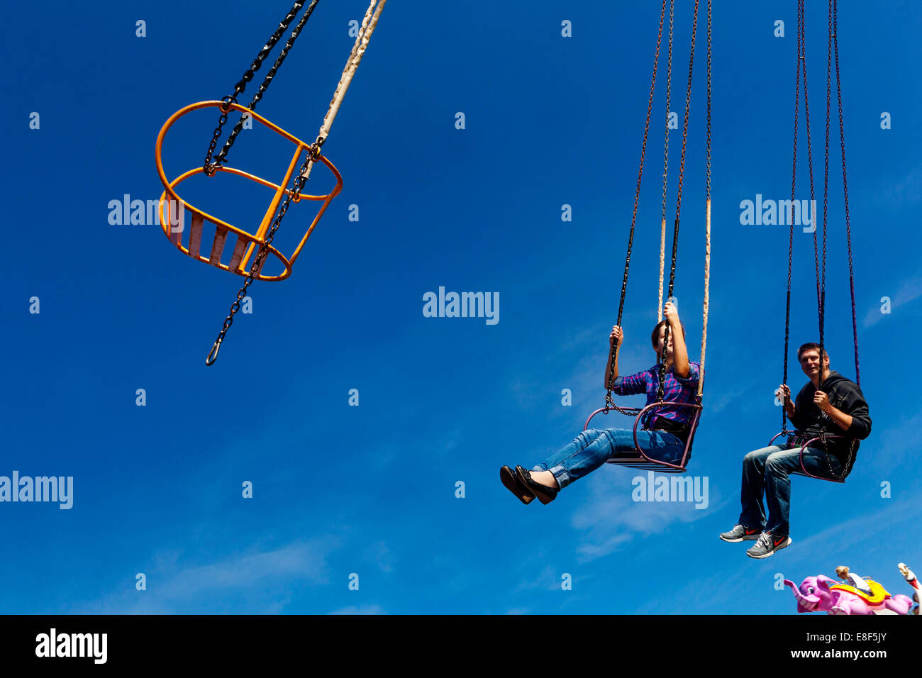 young people on the chain swing carousel, village fair, Czech Republic Stock Photo