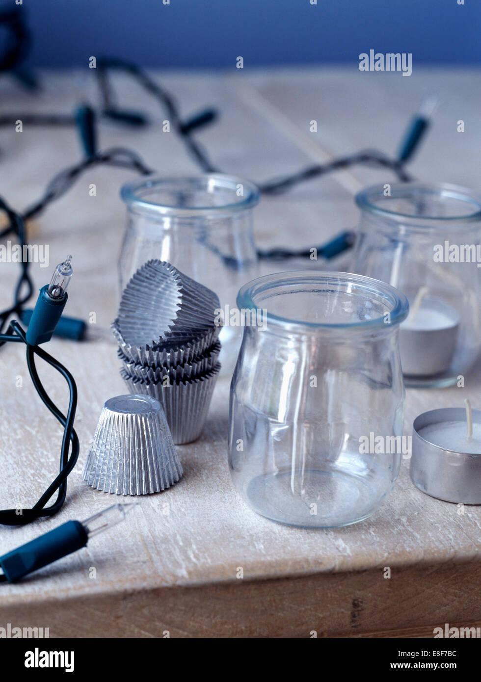 Close-up of Christmas tree lights with small glass jars and corrugated foil cases Stock Photo