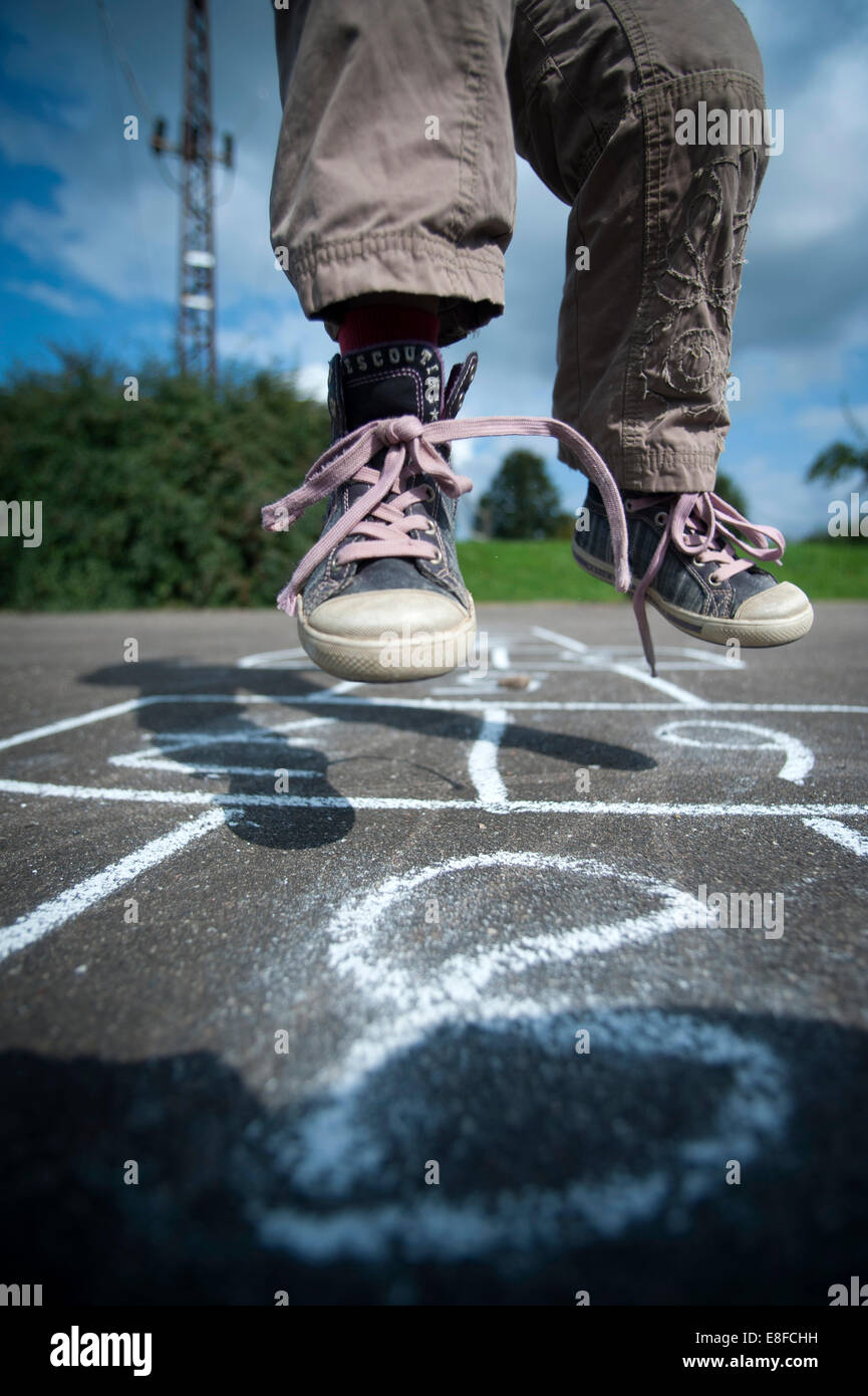 Young girl playing Hopscotch. Stock Photo