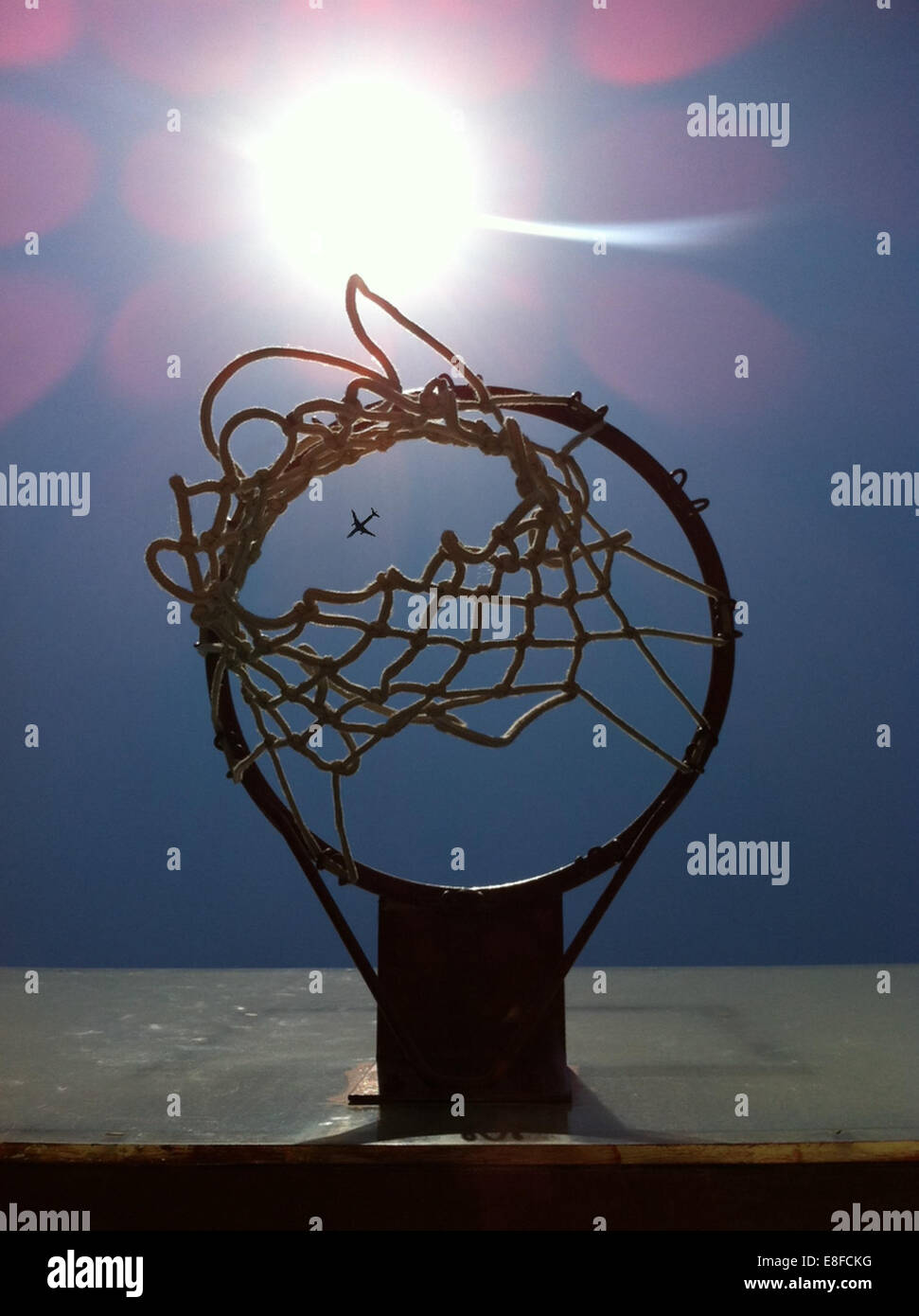 Airplane seen through basketball hoop Stock Photo Alamy