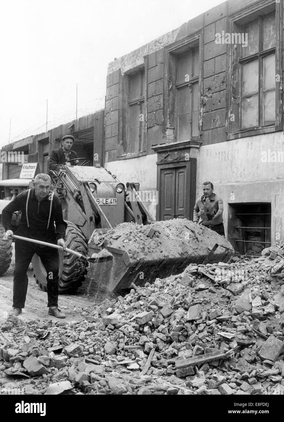 A company from West Berlin clears up debris and rubble on the 28th of September in 1965, which have fallen on West Berlin side after the demoltion of border housesin East Berlin. Stock Photo