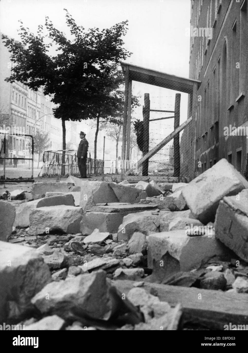 Rubble, which has fallen on the side walk during the demolition of border houses and endangers memorials for the 'Mauertote', people who were killed at Berlin Wall during the attempt to flee the GDR, in Bernauer Street on the 19th of October in 1965. Stock Photo