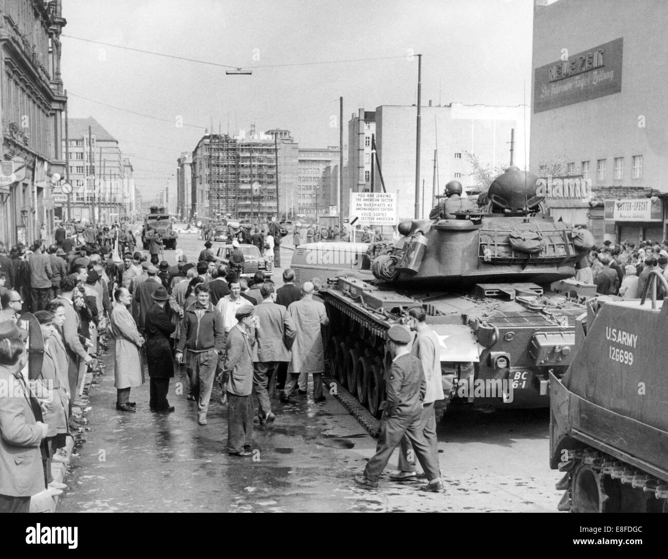 Tanks and soldiers of the US Army standing on the West Berlin side and the People's Police of the GDR, with a water gun, on the East Berlin side, at checkpoint Friedrichstraße in Berlin on 24th August 1961. From 13th August 1961, the day of the building of the wall, until the fall of Berlin Wall on 9th November 1989 the Federal Republic of Germany and the GDR were split by the 'iron curtain' between west and east. Stock Photo