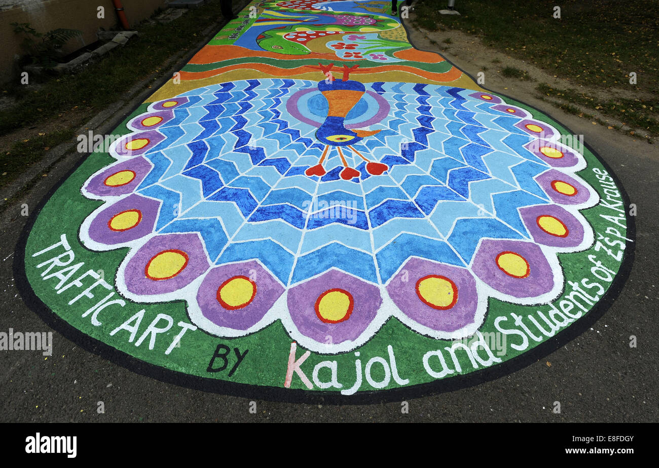 Pardubice, Czech Republic. 7th Oct, 2014. Bangladeshi artist Ruhul Amin Kajol, together with children from a practical and an elementary school, has decorated the pavements outside the buildings with colourful pictures and the director of the former has told CTK the children like them. Kajol, living in Copenhagen, started to change pavements in various places of Europe, Asia and America 20 years ago in order to cheer up people, he said in Pardubice, Czech Republic, on Thursday, October 7, 2014. Credit:  Josef Vostarek/CTK Photo/Alamy Live News Stock Photo