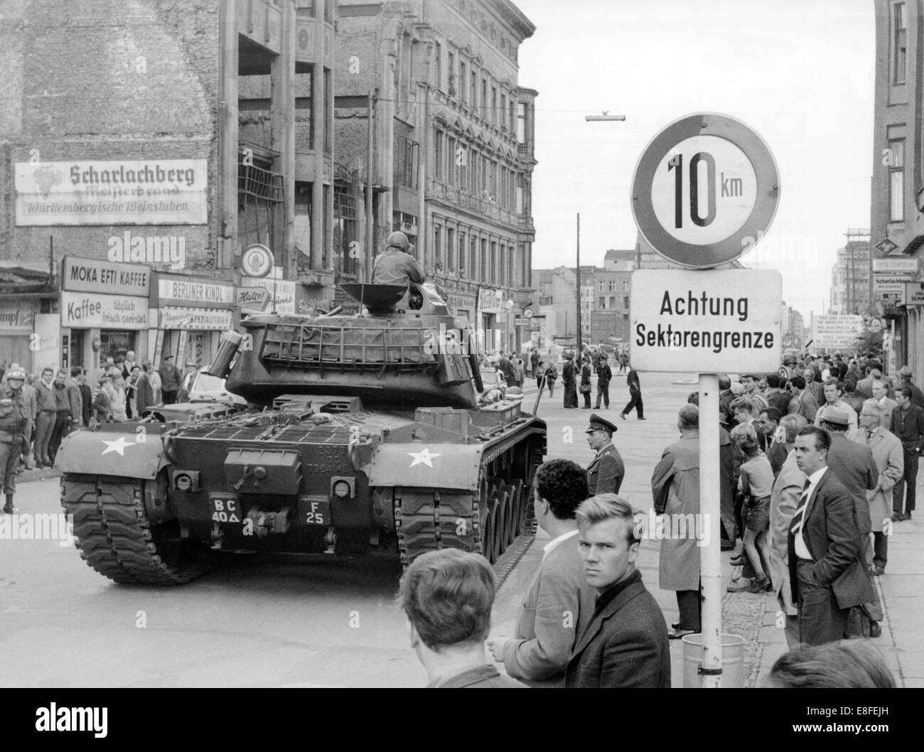 A heavy Patton tank of the US Army at checkpoint Friedrichstraße in the western part of Berlin, on 23rd August 1961. A heavy Patton tank of the US Army standing on Wilhelmstraße in West Berlin at the border to the eastern part of the city, on 23rd August 1961. In the background the Berlin Wall and the 'Haus der Ministerien' (house of ministries), the former Reich aeronautic ministry, at the corner of Wilhelm and Leipziger Straße. From 13th August 1961, the day of the building of the wall, until the fall of Berlin Wall on 9th November 1989 the Federal Republic of Germany and the GDR were split  Stock Photo