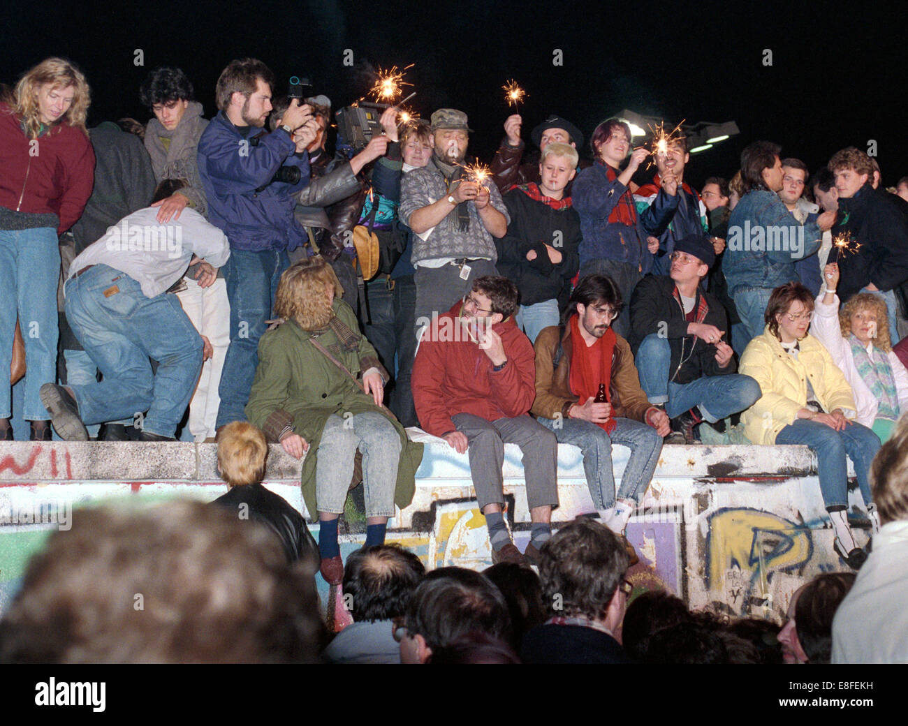 One day after the opening of the border, thousands of people celebrate on, in front of and behind Berlin Wall at Brandenburg Gate in Berlin on 10 November 1989 (western side). The inner-German border which had separated the country since 1961 practically ceased to exist. Photo: Peter Zimmermann Stock Photo