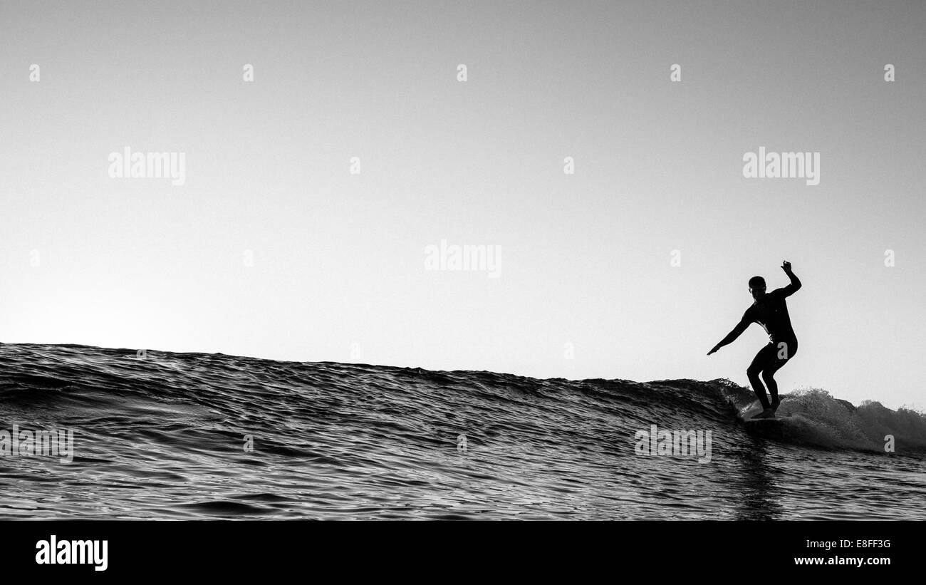 Silhouette of a surfer surfing, California, USA Stock Photo