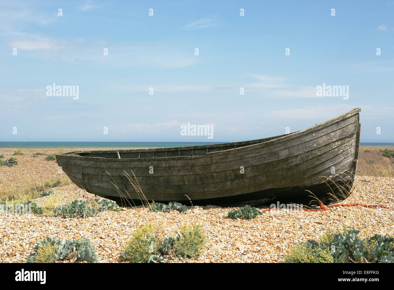 Old rowing boat on pebble beach hires stock photography and images Alamy
