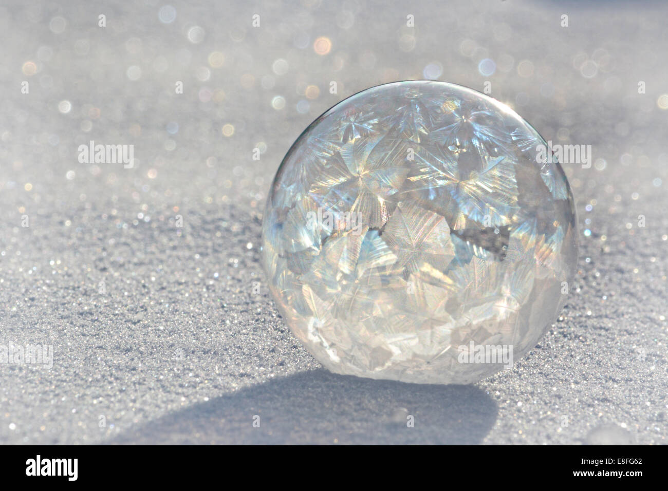 Frozen soap bubble on ice Stock Photo
