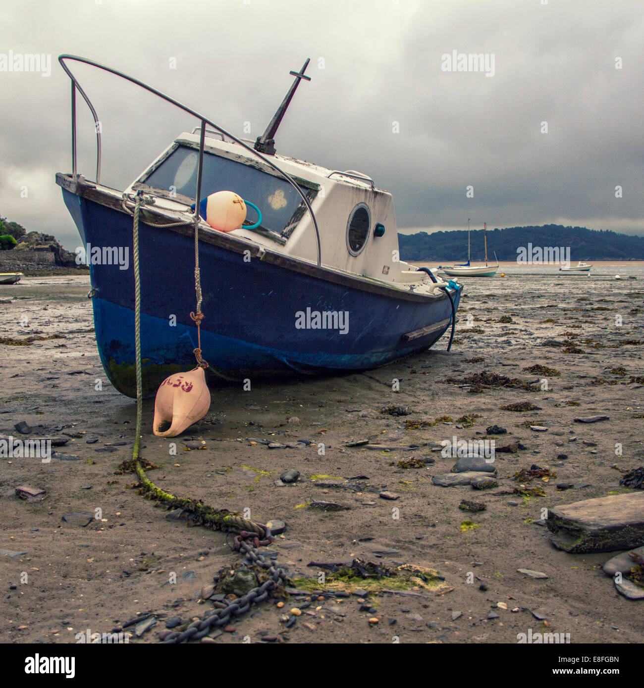 Fishing Boat on beach at low tide Stock Photo - Alamy