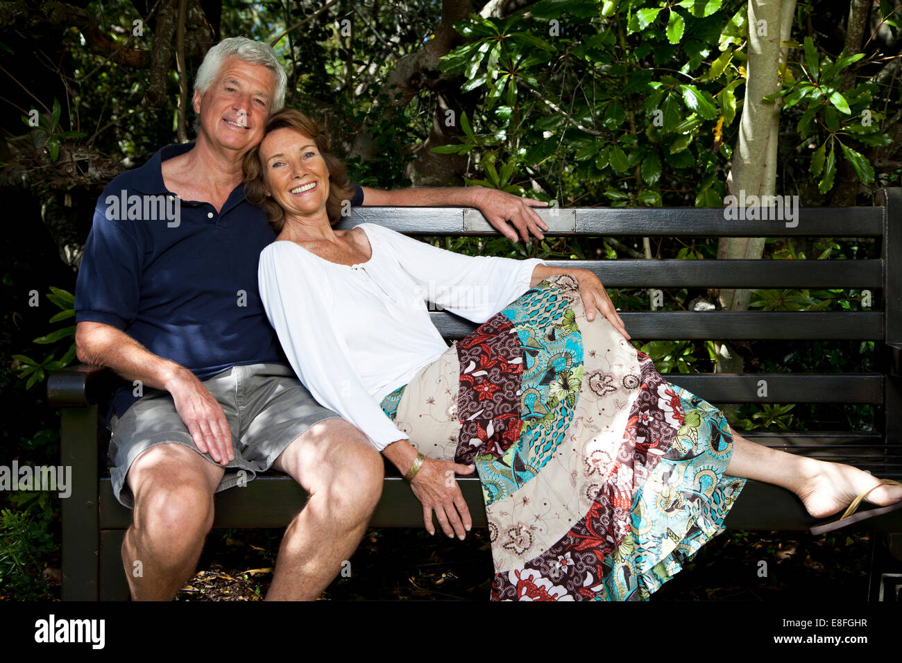 Senior couple sitting on garden bench Stock Photo - Alamy