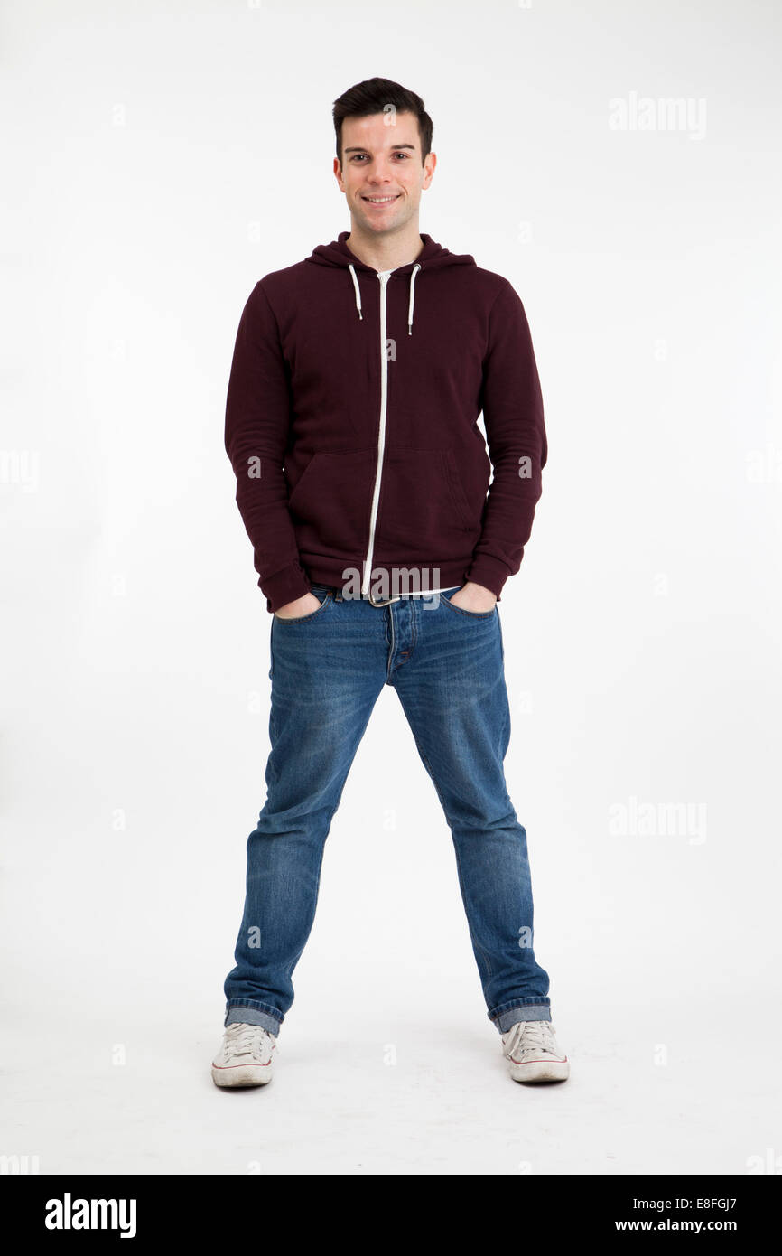 Portrait of a man standing with his hands in his pockets Stock Photo ...
