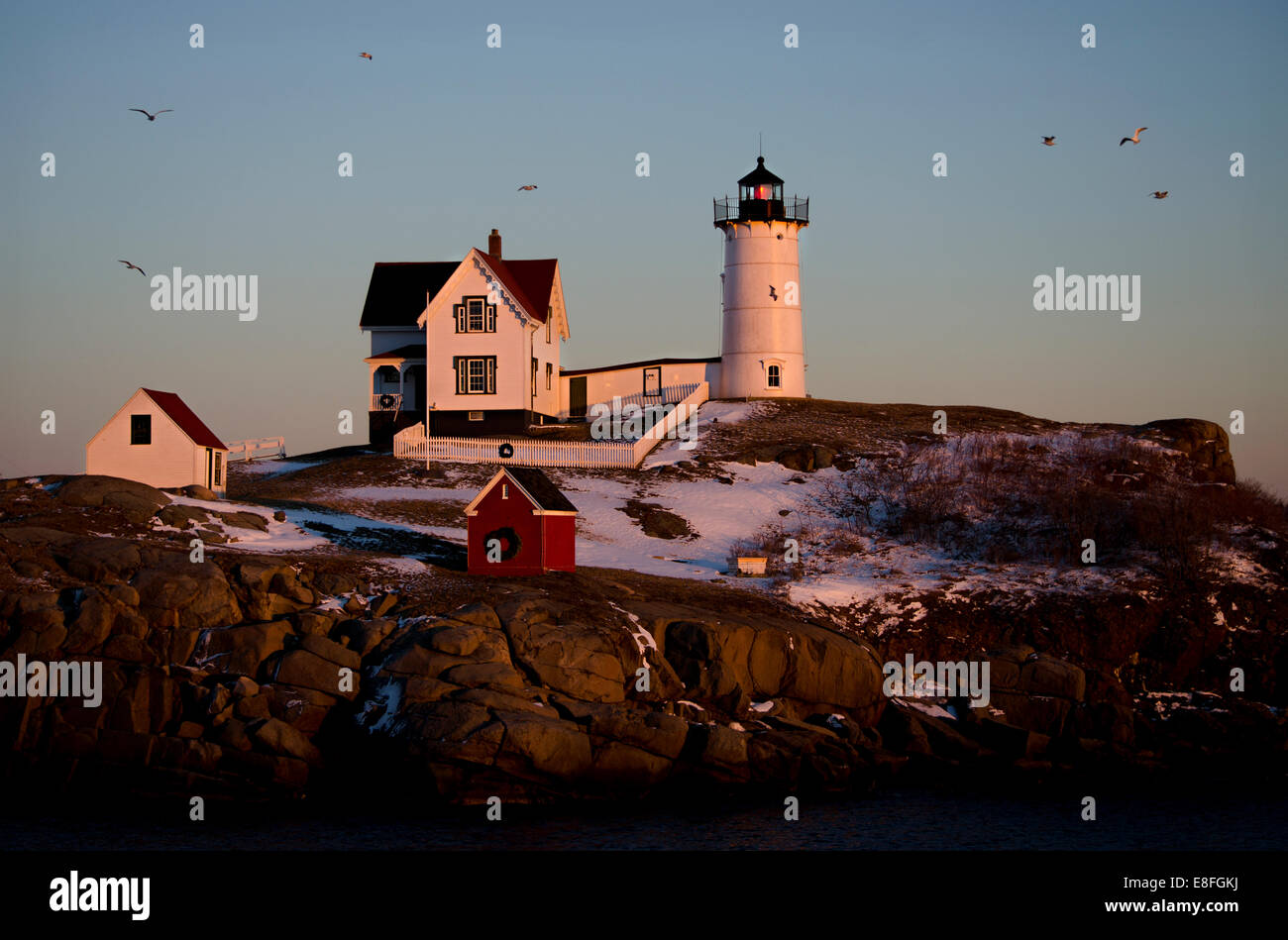 USA, Maine, York County, Cape Neddick Lighthouse in winter sunset Stock Photo