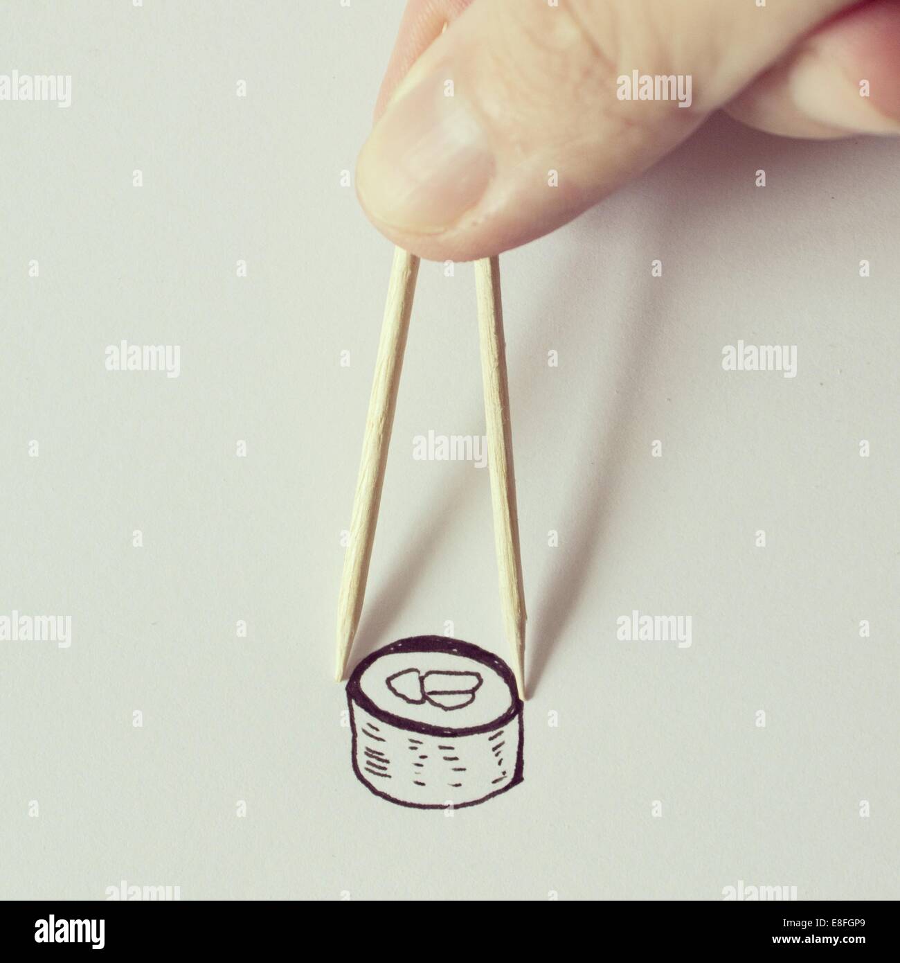 Man eating conceptual nigiri sushi with chopsticks Stock Photo