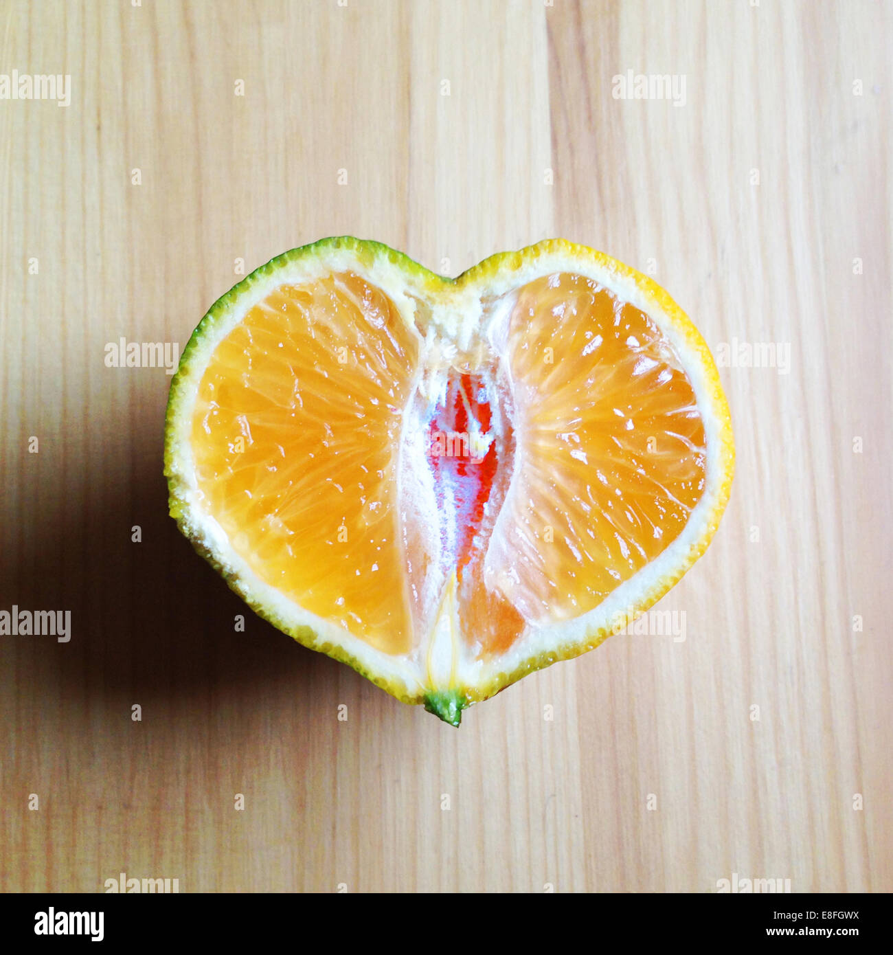 Heart shaped orange cut in half Stock Photo