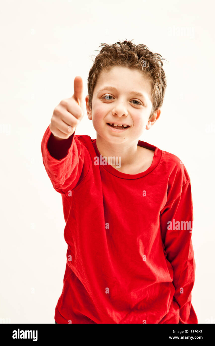 Young boy giving thumbs up gesture Stock Photo - Alamy