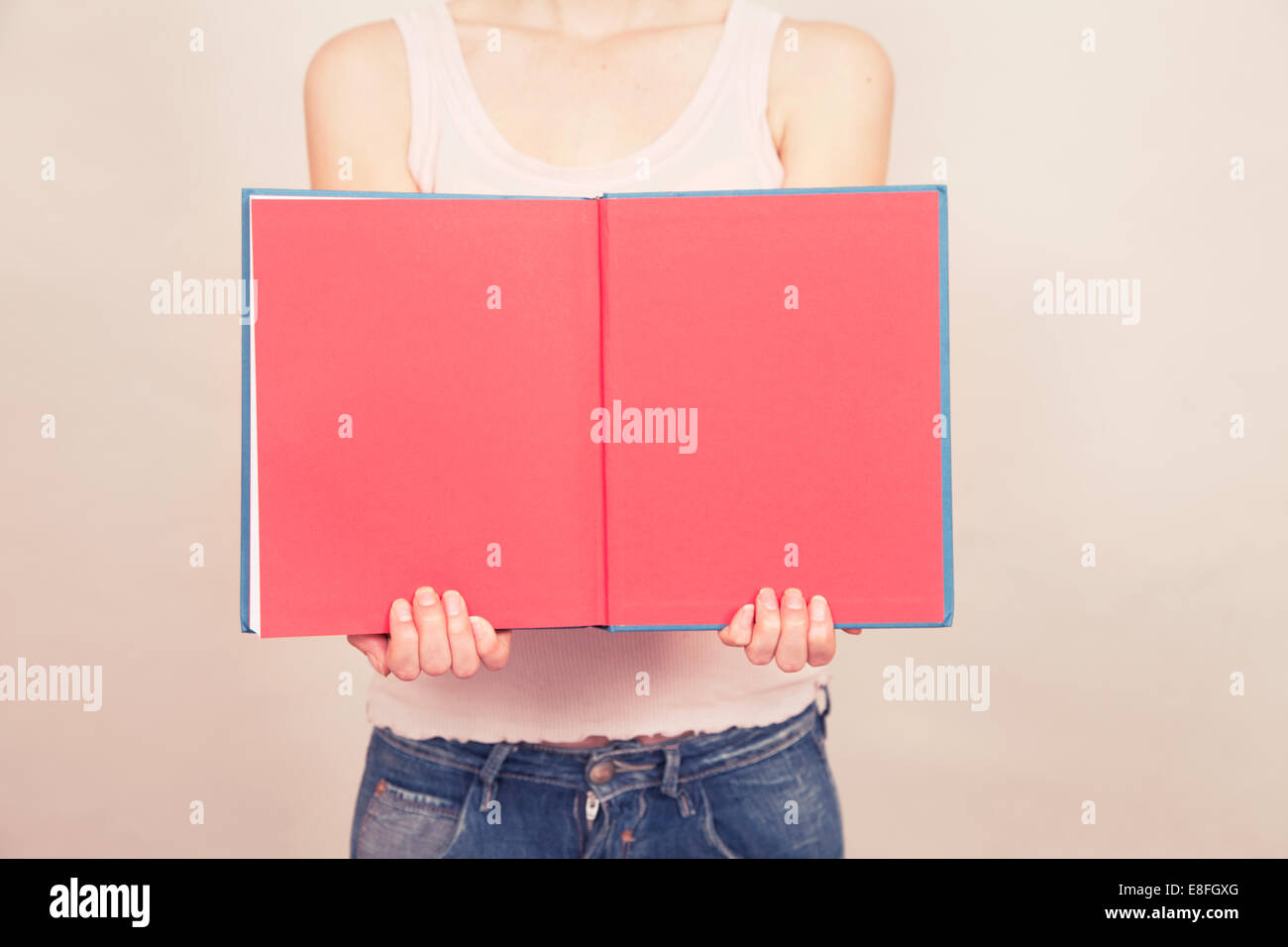 Woman holding book open with blank pages Stock Photo