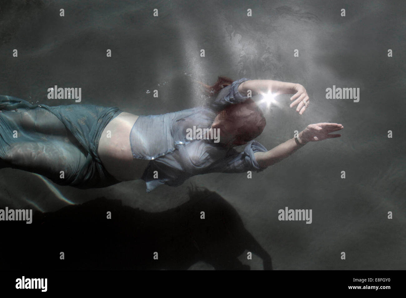 Fully clothed Pregnant woman swimming underwater Stock Photo Alamy