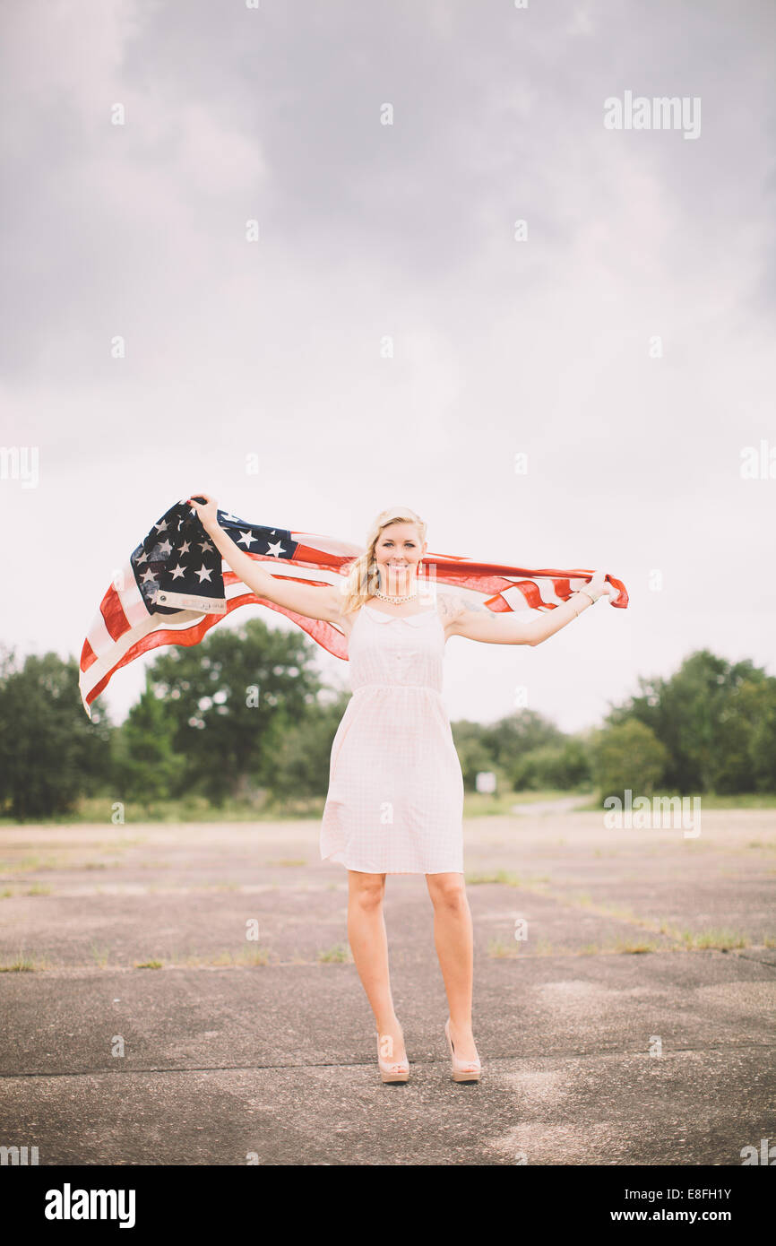 Portrait of a woman holding an American flag, Fort Walton Beach, Florida, USA Stock Photo