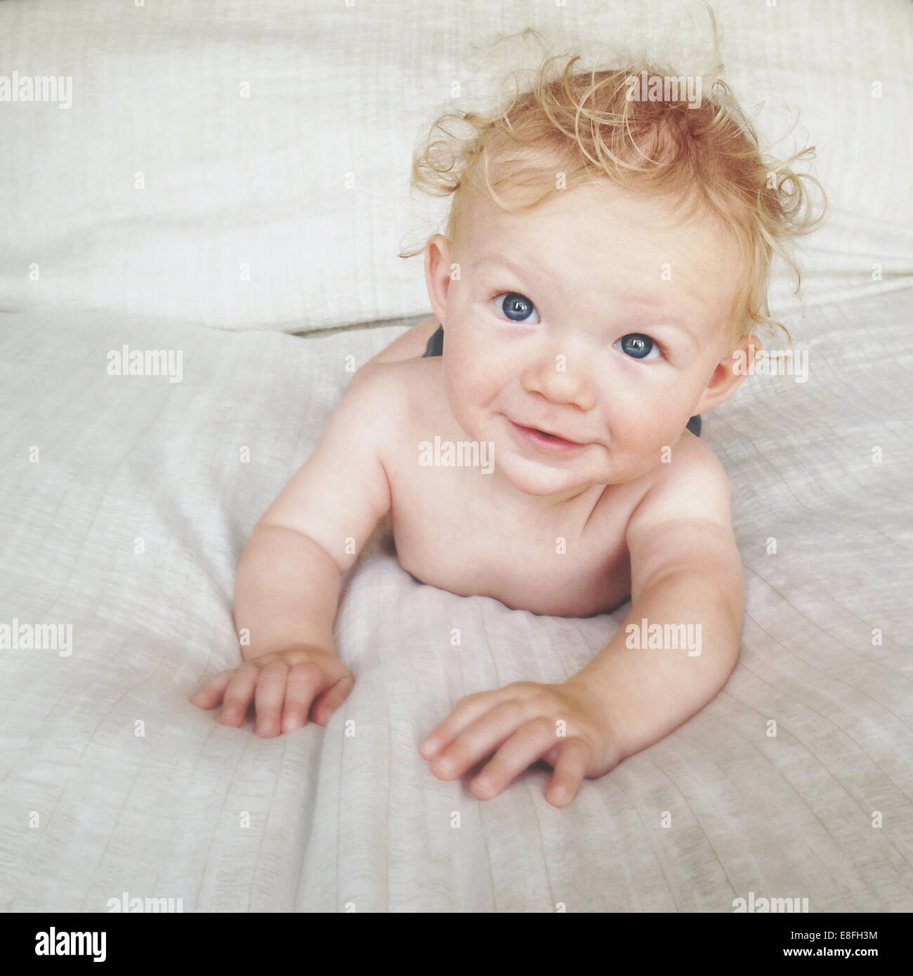 Portrait of boy lying on a bed Stock Photo