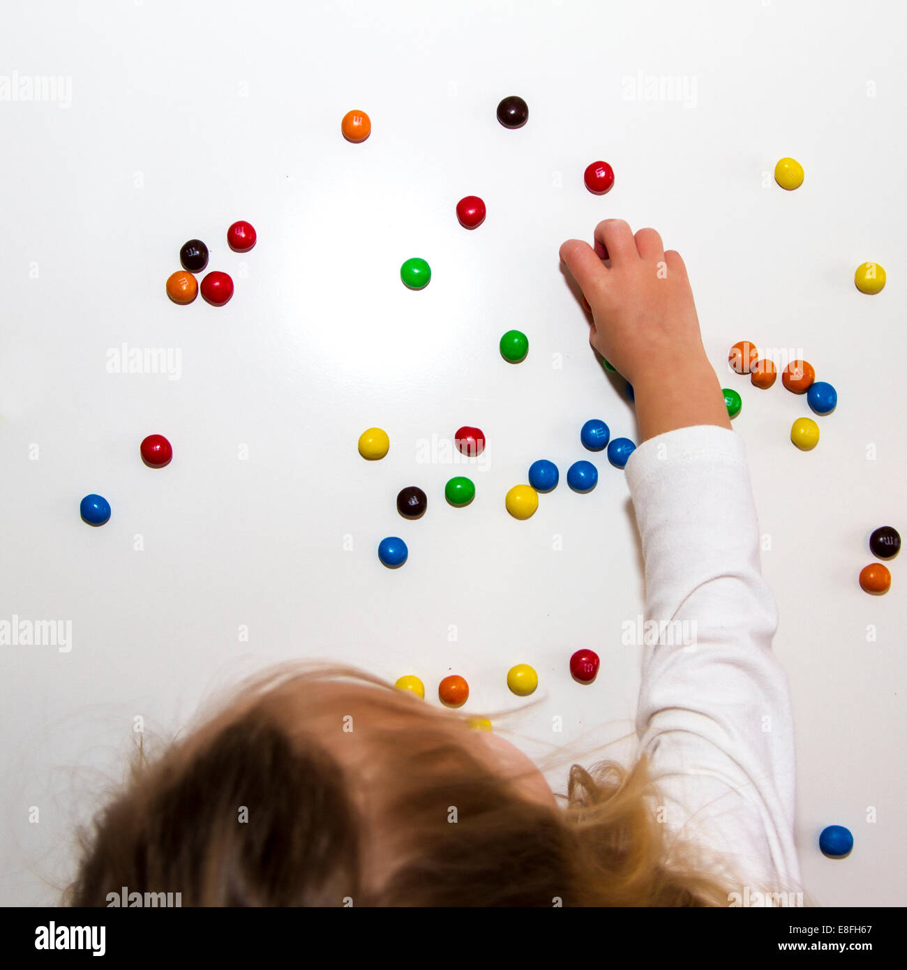 Girl eating chocolate candies Stock Photo Alamy