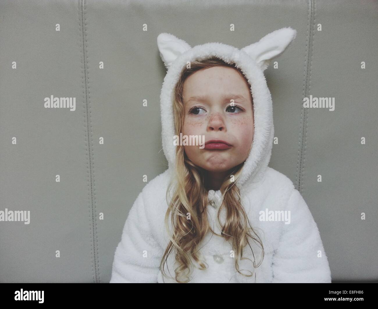 Girl in bunny rabbit costume pulling funny faces Stock Photo