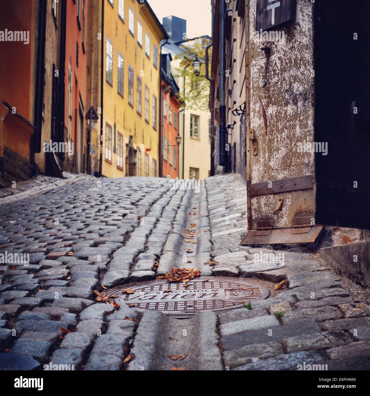 Sweden, Svealand, Stockholm,  Manhole cover in cobbled street Stock Photo
