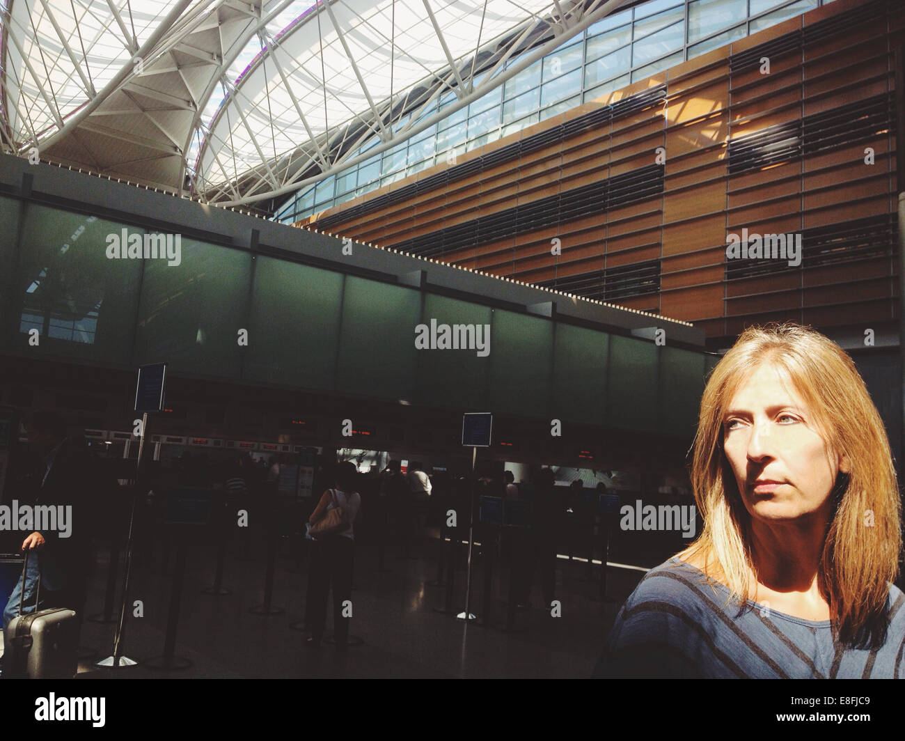 Blonde woman in airport hi-res stock photography and images - Alamy