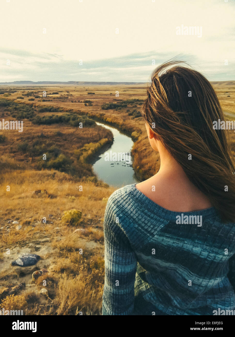 Canada, Saskatchewan, Val Marie, Rear view of woman overlooking prairie and river vista in fall Stock Photo