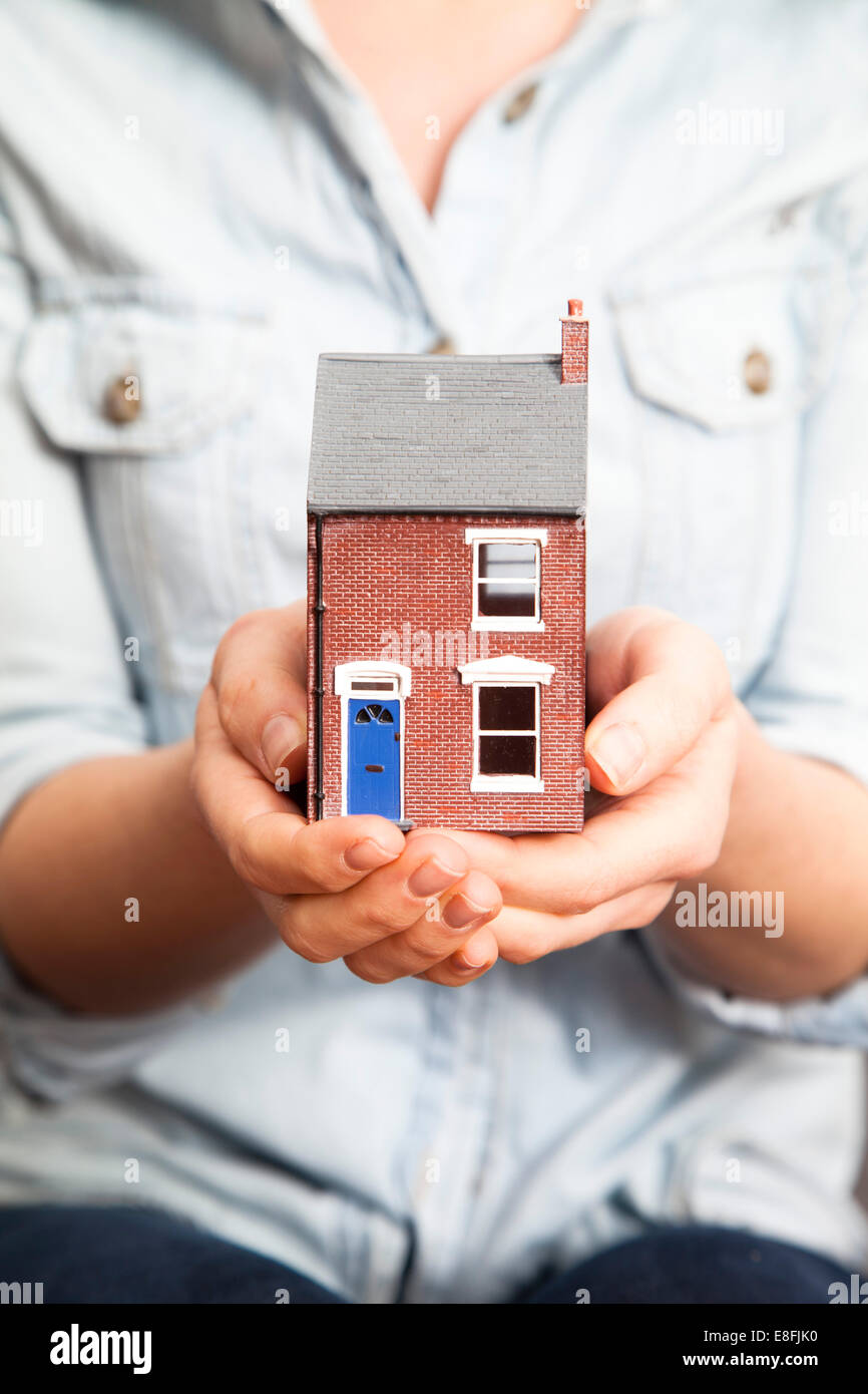 Close-up of a woman holding a model house Stock Photo - Alamy