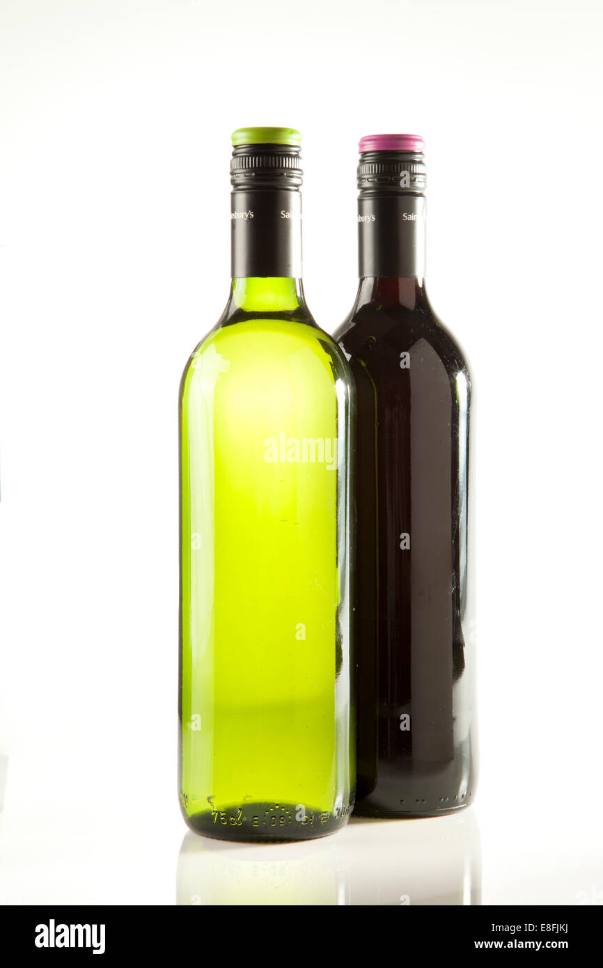 Closeup of a bottle of red wine and a bottle of white wine on a table