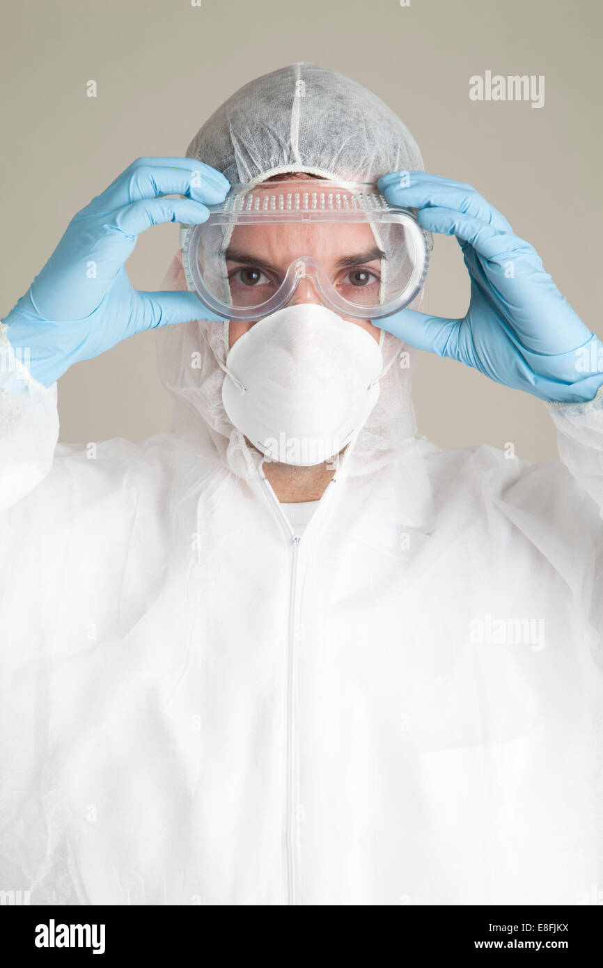 Scientist wearing protective suit, mask and safety glasses Stock Photo