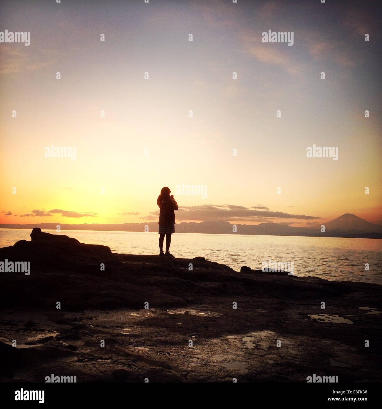 Rear View Of A Woman Standing By The Sea Stock Photo - Alamy