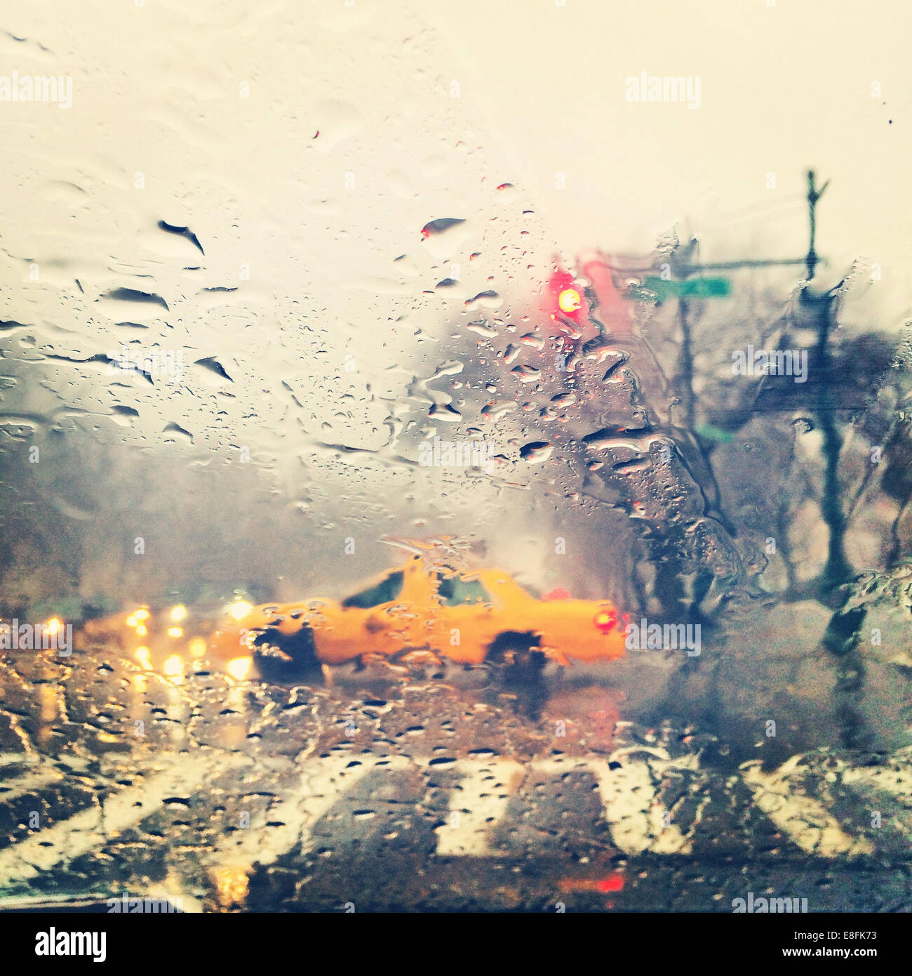 Yellow taxi cab driving in the rain, Brooklyn, New York, USA Stock Photo