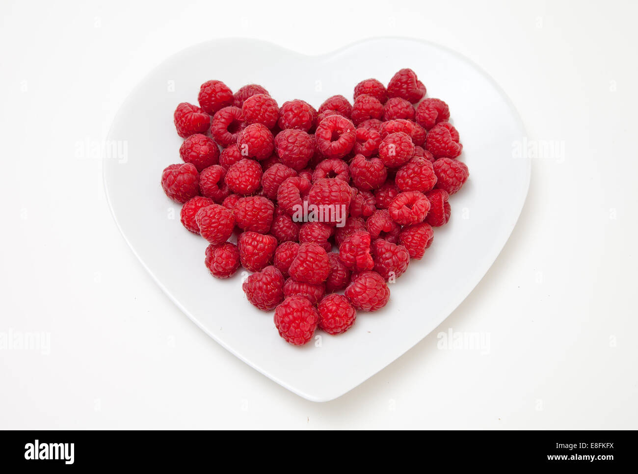 Raspberries on heart shaped plate Stock Photo