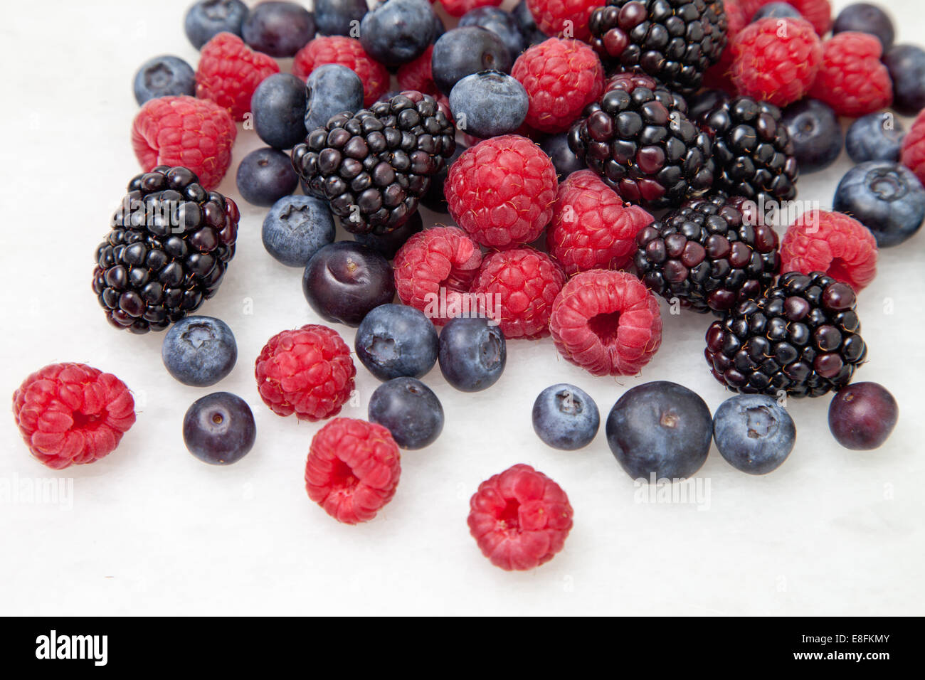 Close-up overhead view of fresh blueberries, raspberries and blackberries on a table Stock Photo