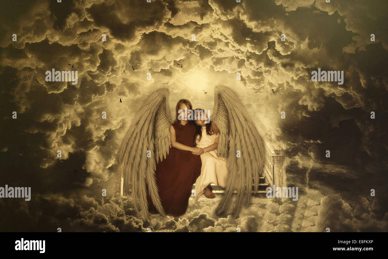 Two girls dressed as angels sitting on steps to heaven Stock Photo