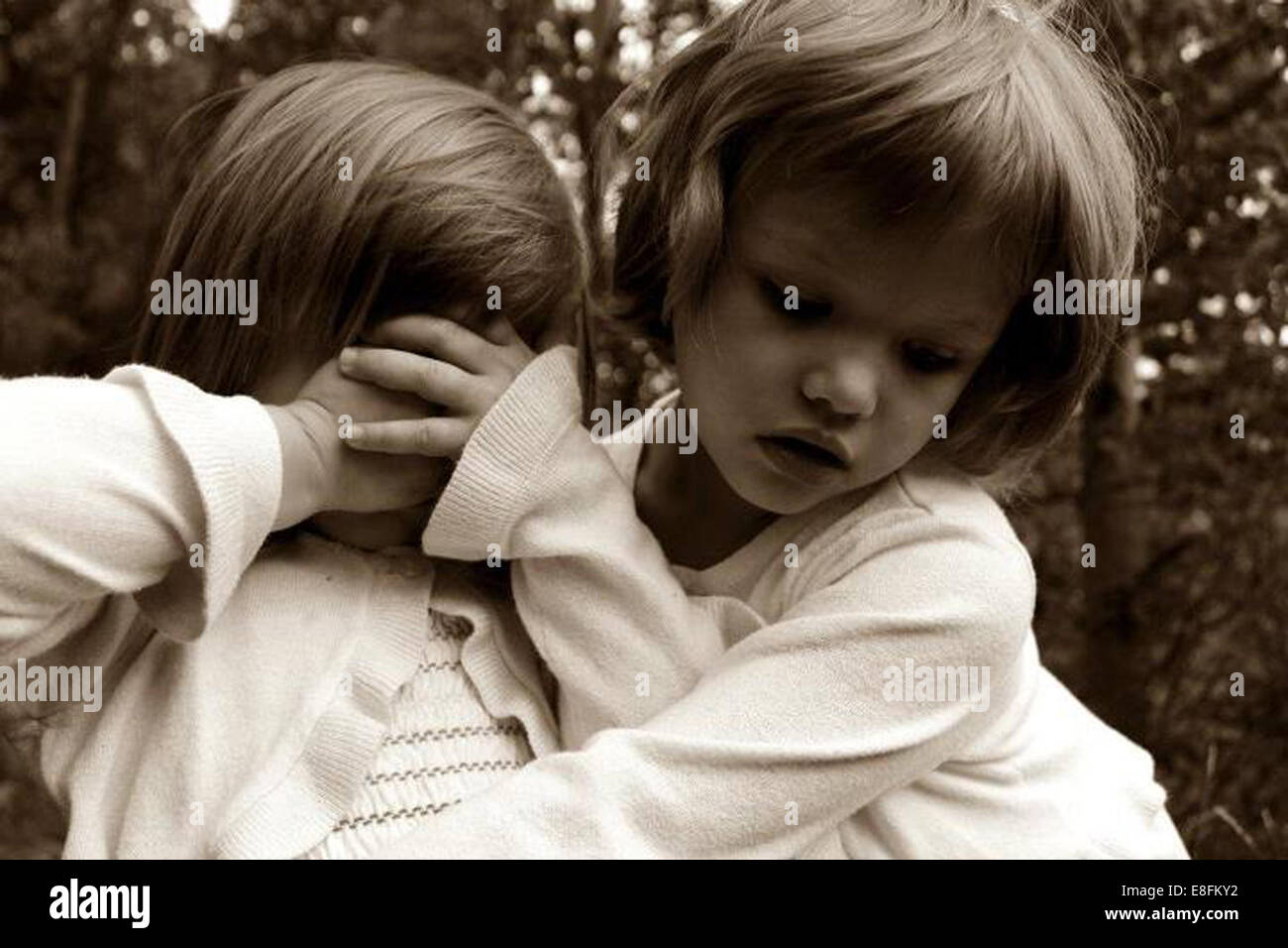 Portrait of two girls hugging in the woods Stock Photo - Alamy