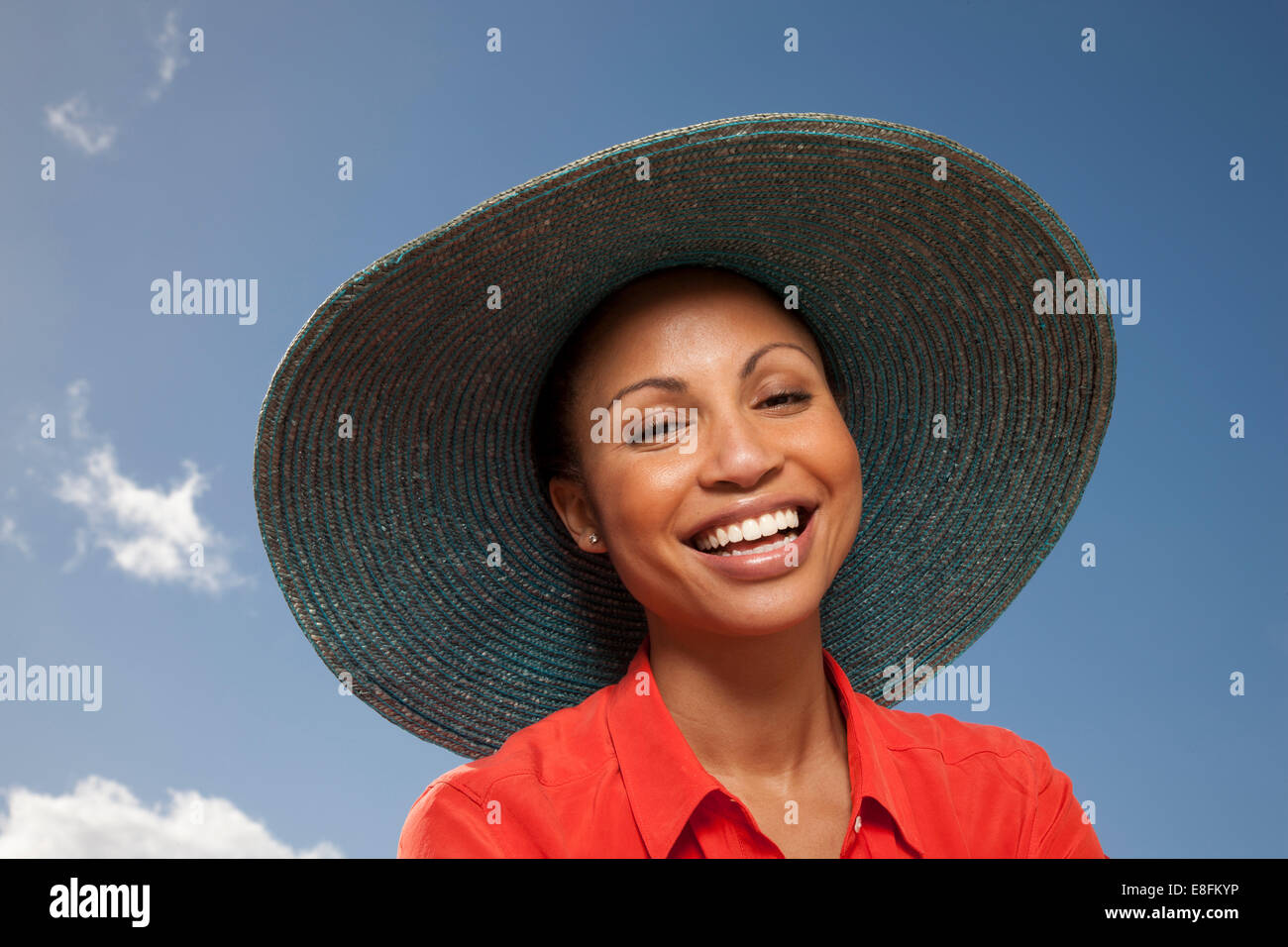 Portrait of smiling woman wearing straw hat Stock Photo - Alamy